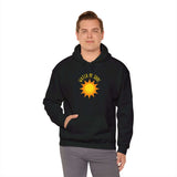 Stylish man wearing the Watch Me Shine Men's Graphic Hoodie with bold sun design, perfect for casual or event wear.