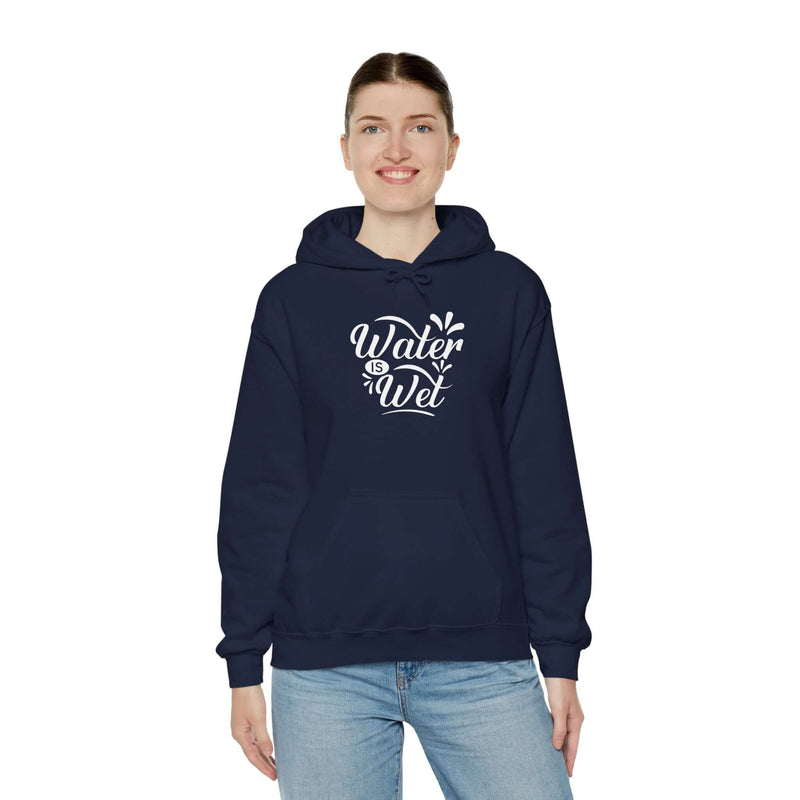 Woman wearing a navy blue 'Water Is Wet' graphic hoodie, perfect for stylish casual wear and cozy days.