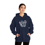 Woman wearing a stylish navy blue hoodie with 'Water Is Wet' graphic design, perfect for casual outings.