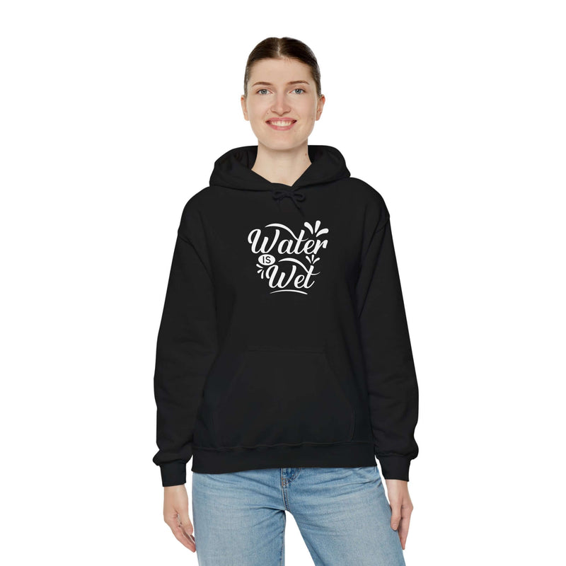 Woman wearing a black 'Water Is Wet' graphic hoodie, perfect for casual wear and showcasing personal style.