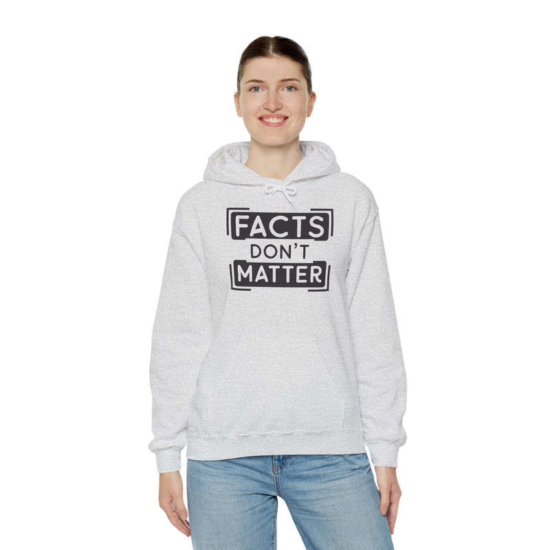 Woman wearing gray 'Facts Don't Matter' graphic hoodie, featuring a kangaroo pocket and adjustable drawstring hood.